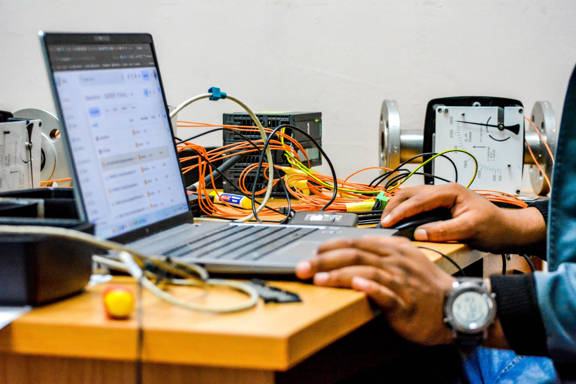 Qanchis engineer working at an instrumentation test bench
